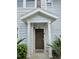 Inviting front door entrance with a peaked roof, light blue siding, and lush landscaping at 5354 Diplomat Ct # 105, Kissimmee, FL 34746