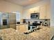 Modern kitchen with stainless steel appliances, granite counters, and ample cabinet space at 5354 Diplomat Ct # 105, Kissimmee, FL 34746