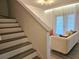 Elegant staircase leading to a naturally lit living room with stylish furnishings at 5354 Diplomat Ct # 105, Kissimmee, FL 34746