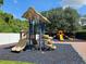 Community playground with colorful play equipment and shaded by mature trees in a secure setting at 5354 Diplomat Ct # 105, Kissimmee, FL 34746