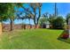 Well-maintained backyard featuring a brick wall, a storage shed, and lush green grass at 5388 Birchbend Loop, Oviedo, FL 32765