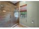 Bathroom featuring a tiled walk-in shower and a window providing natural light at 5388 Birchbend Loop, Oviedo, FL 32765