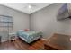 Bedroom with wood floors, a TV, and natural light from the window at 5388 Birchbend Loop, Oviedo, FL 32765
