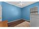 Cozy bedroom showcasing sleek wood floors, neutral-toned walls, and bright natural light at 5388 Birchbend Loop, Oviedo, FL 32765