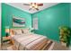Stylish bedroom featuring a queen bed, vibrant walls, and a large window for natural light at 5388 Birchbend Loop, Oviedo, FL 32765