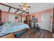 Cozy bedroom boasting a wooden four-poster bed frame, wood floors, and plenty of space at 5388 Birchbend Loop, Oviedo, FL 32765