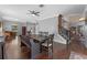 A dining room features dark wood floors, a fan, and a long, dark wood dining table with an ornate bench and chairs at 5388 Birchbend Loop, Oviedo, FL 32765