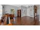 Bright living room with hardwood floors, desk, and a view of the front yard at 5388 Birchbend Loop, Oviedo, FL 32765