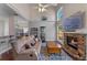 A large living room showcases a fireplace with a brick surround, dark wood floors, high ceilings, and clerestory windows at 5388 Birchbend Loop, Oviedo, FL 32765