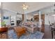 Open living area with dark wood floors, a brick accent wall that connects to the kitchen, and stairs leading to the second floor at 5388 Birchbend Loop, Oviedo, FL 32765