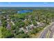 Aerial view of a home nestled in a treelined neighborhood close to a lake at 5388 Birchbend Loop, Oviedo, FL 32765