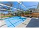 Refreshing screened-in pool surrounded by a concrete deck and well-maintained landscaping at 5388 Birchbend Loop, Oviedo, FL 32765