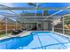 Beautiful backyard pool featuring a screened-in enclosure, deck, and views of the fenced yard at 5388 Birchbend Loop, Oviedo, FL 32765