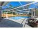 Inviting screened-in pool area featuring comfortable seating and a view of the surrounding backyard at 5388 Birchbend Loop, Oviedo, FL 32765