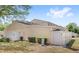 Exterior view of backyard with privacy fence, patio, and well-maintained lawn at 5395 Emerald Isle Drive # 1011, Orlando, FL 32812