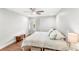 Bright bedroom features hardwood floors, a ceiling fan, and neutral decor at 5395 Emerald Isle Drive # 1011, Orlando, FL 32812