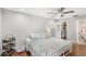 A cozy bedroom featuring wood floors, a ceiling fan, and a walk-in closet for ample storage at 5395 Emerald Isle Drive # 1011, Orlando, FL 32812