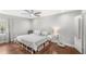 Bedroom features hardwood floors, ceiling fan, neutral paint, and walk-in closet at 5395 Emerald Isle Drive # 1011, Orlando, FL 32812