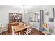Bright dining room with wood floors, display cabinet, and contemporary chandelier lighting at 5395 Emerald Isle Drive # 1011, Orlando, FL 32812