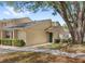 Charming home enhanced by a mature tree that offers shade and beauty, complemented by lush landscaping at 5395 Emerald Isle Drive # 1011, Orlando, FL 32812
