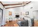 Cozy living room featuring hardwood floors, vaulted ceilings with wood beams, and stylish decor at 5395 Emerald Isle Drive # 1011, Orlando, FL 32812