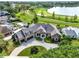 Stunning aerial view of a luxury estate with a pool, golf course, and lake access at 5640 Brookline Dr, Orlando, FL 32819