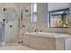 Modern soaking tub and shower with unique tiling and natural light from a window at 5640 Brookline Dr, Orlando, FL 32819