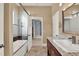 Bright bathroom featuring a shower-tub combo with glass door and a vanity with granite countertop at 5640 Brookline Dr, Orlando, FL 32819