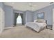 Light blue bedroom with neutral carpet, ceiling fan, and double hung windows at 5640 Brookline Dr, Orlando, FL 32819