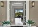 Grand entryway with an arched ceiling, elegant light fixtures, and scenic backyard views at 5640 Brookline Dr, Orlando, FL 32819