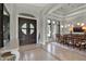 Bright foyer featuring a decorative tiled floor border, dark double doors, and a modern white accent table at 5640 Brookline Dr, Orlando, FL 32819