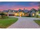 Beautiful home with a paver driveway and manicured landscaping, seen at twilight at 5640 Brookline Dr, Orlando, FL 32819