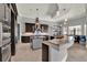 A modern kitchen with a curved breakfast bar, a kitchen island, pendant lights and sleek appliances at 5640 Brookline Dr, Orlando, FL 32819