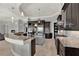 A modern kitchen with a curved breakfast bar, a kitchen island, pendant lights and sleek appliances at 5640 Brookline Dr, Orlando, FL 32819