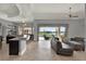 Open-concept living room with a view of the pool, featuring modern furniture and neutral tones at 5640 Brookline Dr, Orlando, FL 32819