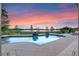 Relaxing poolside view with a backdrop of lush greenery, a tranquil lake, and a colorful sunset at 5640 Brookline Dr, Orlando, FL 32819