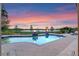 Relaxing poolside view with fire bowls overlooking a tranquil lake, and a colorful sunset at 5640 Brookline Dr, Orlando, FL 32819