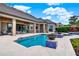 Beautiful pool area with an inviting blue pool, patio furniture, and tropical landscaping at 5640 Brookline Dr, Orlando, FL 32819
