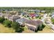 An aerial view shows a neighborhood of single-Gathering homes surrounding a small pond at 5803 Cheshire Cove Ter, Orlando, FL 32829