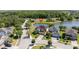 An aerial view shows a house on a cul-de-sac next to a community pond at 5803 Cheshire Cove Ter, Orlando, FL 32829