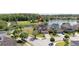 An aerial view shows a house on a cul-de-sac next to a community pond at 5803 Cheshire Cove Ter, Orlando, FL 32829