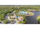 Aerial view of clubhouse, pool and parking area in a well-maintained community at 5803 Cheshire Cove Ter, Orlando, FL 32829