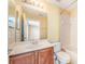Well-lit bathroom featuring a single sink vanity and a shower-tub combo at 5803 Cheshire Cove Ter, Orlando, FL 32829