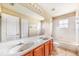 Bright bathroom featuring a double sink vanity and a shower-tub combo at 5803 Cheshire Cove Ter, Orlando, FL 32829