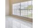 Sunlit bedroom featuring sleek marble floors, neutral walls, and bright windows at 5803 Cheshire Cove Ter, Orlando, FL 32829