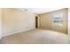 Bedroom with neutral carpet and walls, and a window with blinds at 5803 Cheshire Cove Ter, Orlando, FL 32829