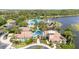 Aerial view of community clubhouse, pool, parking and mature landscaping at 5803 Cheshire Cove Ter, Orlando, FL 32829