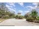 Well-maintained community entrance featuring brick paving, mature trees and landscaping at 5803 Cheshire Cove Ter, Orlando, FL 32829