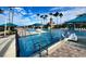 View of community pool with sundeck, lounge chairs and shade umbrellas at 5803 Cheshire Cove Ter, Orlando, FL 32829