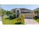 Inviting two-story home with a well-manicured lawn and a two-car garage, perfect for Gathering living at 5803 Cheshire Cove Ter, Orlando, FL 32829